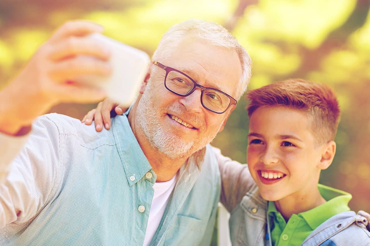 older man talking selfie with boy