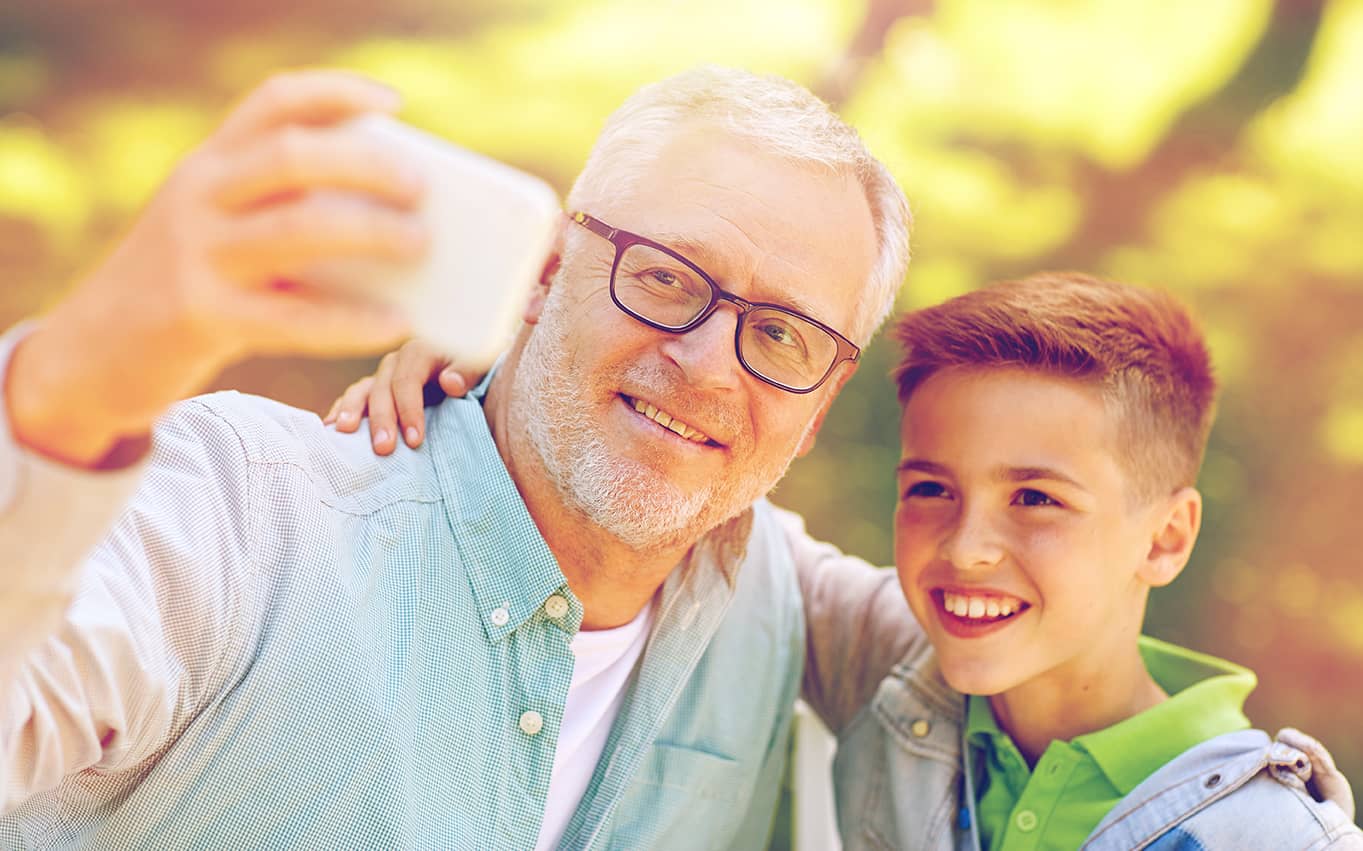 older man talking selfie with boy